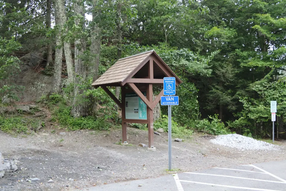 An accessible parking space (van accessible) sits in front of the Bash Bish falls trailhead.