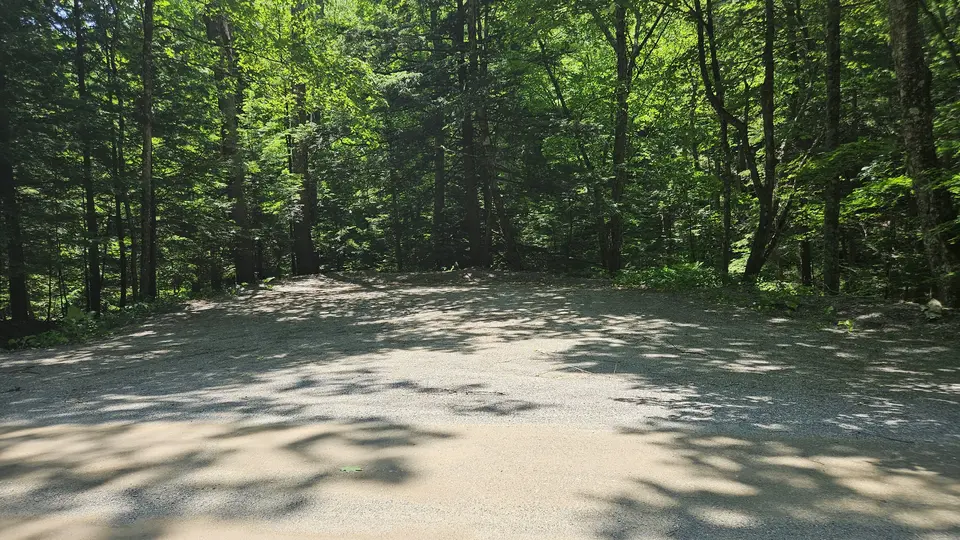 The parking area, made of compacted gravel and dirt