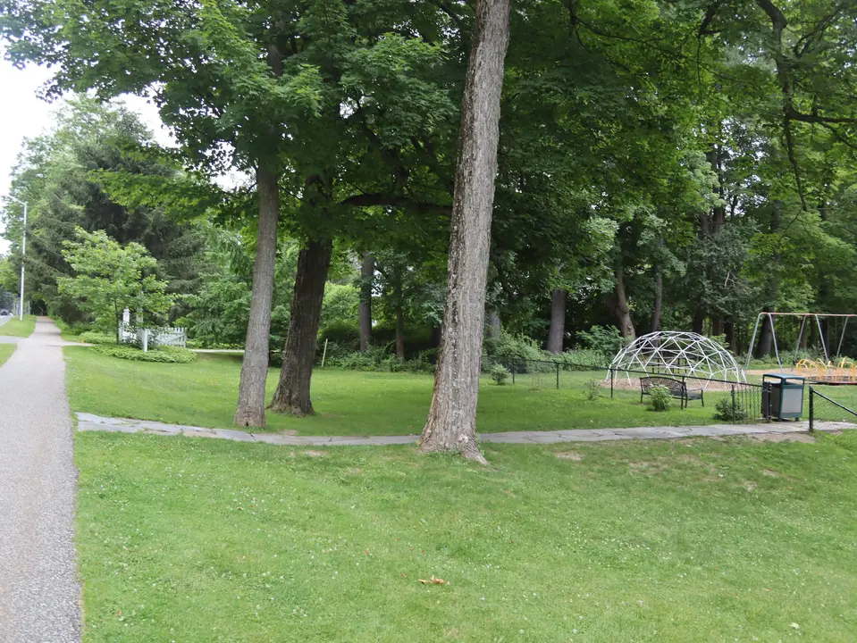 A concrete pathway connects the Bidwell Park Playground to a sidewalk.