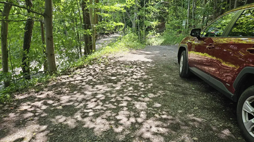 The small parking area, made of pressed dirt