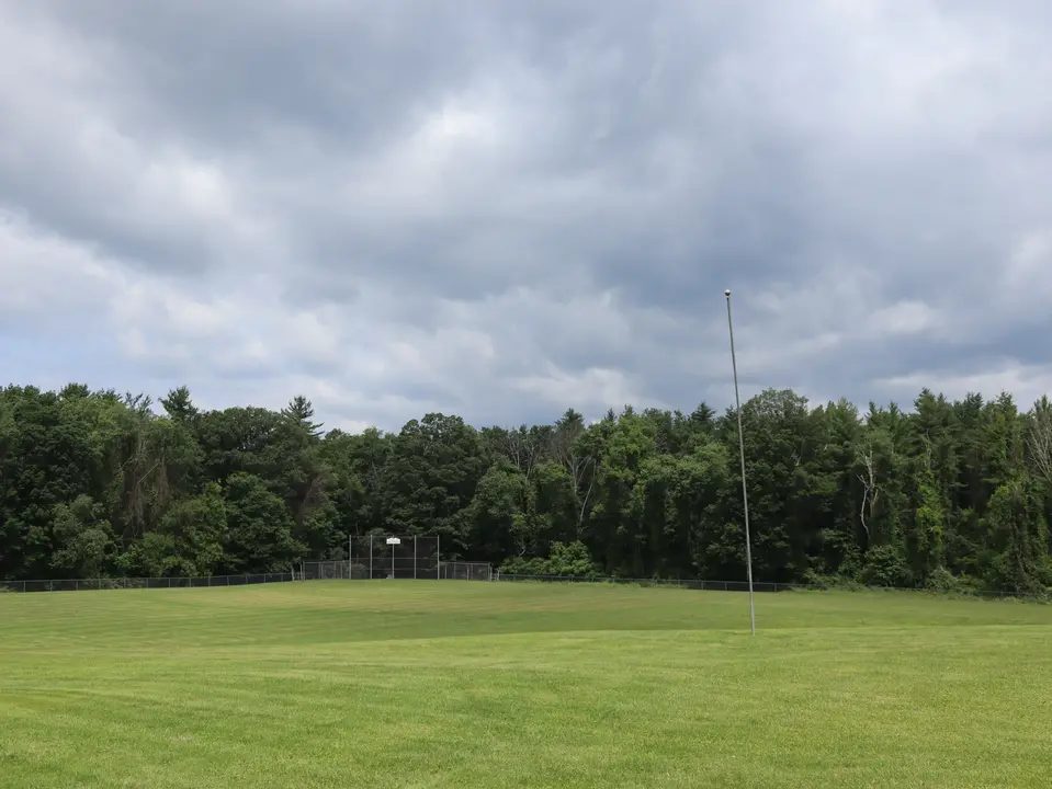 A baseball field sits next to the French Dog Park.
