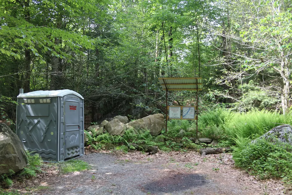 Portable restroom and information kiosk in the Hanging Mountain parking area.