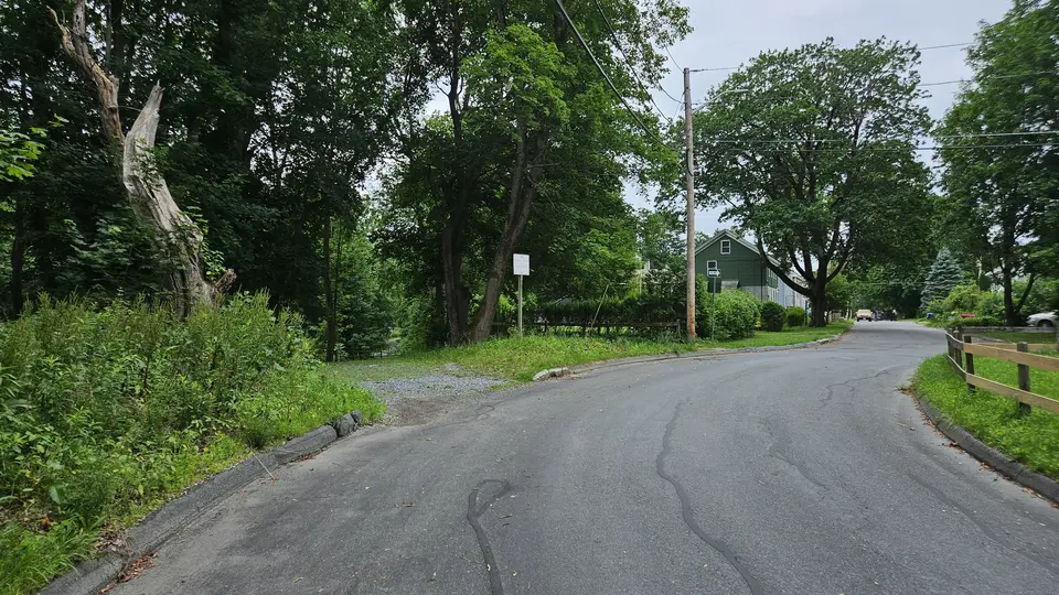 The driveway by the small parking area.