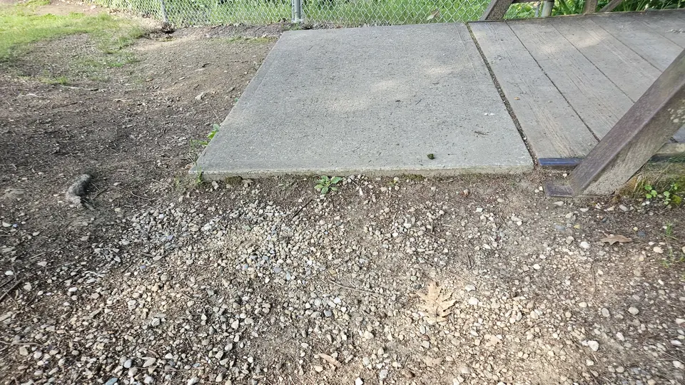 The 1.5'' elevated concrete slab that connects to the bridge, leading to the hiking trails.