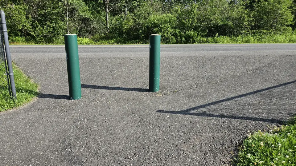 The bollards between the path and road, with a 5.5' gap on the right side.