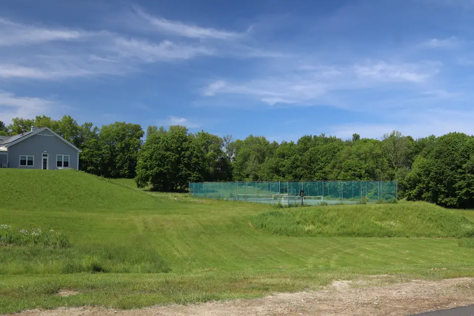 View of the Richmond Tennis Courts from the parking lot of Richmond Consolidated School. Richmond Town Hall stands to the right in the distance.