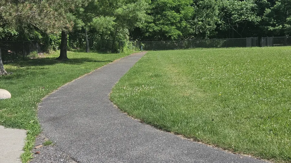 The sidewalk looping around the park
