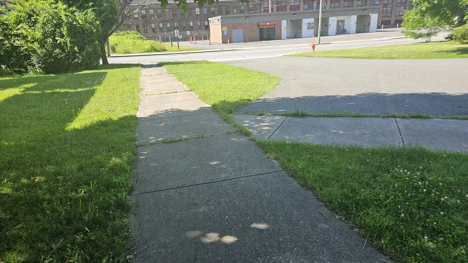The sidewalk connecting to the parking lot