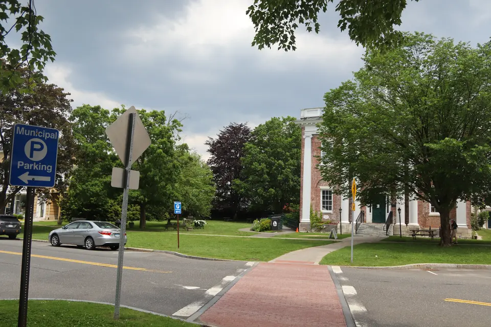 A crosswalk crosses Main Street in Lenox, leading to the Roche Reading Park ahead.