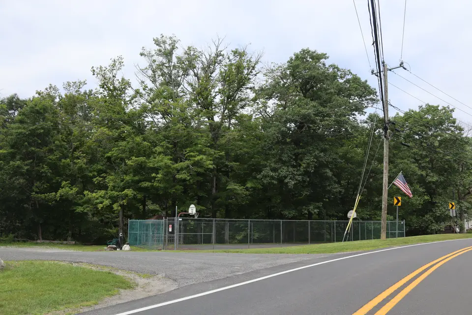 View of the entrance to the Library parking lot (left) from Sandisfield Road.