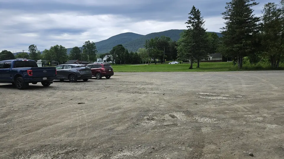 The packed dirt parking lot.