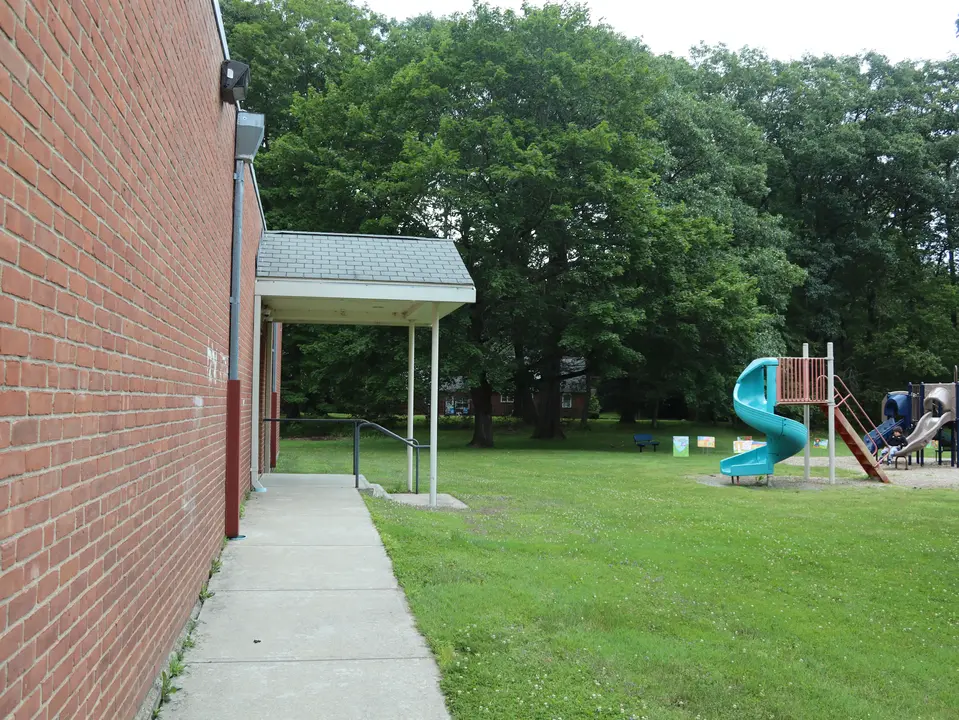 Park features separated by grass from the West Stockbridge Library.
