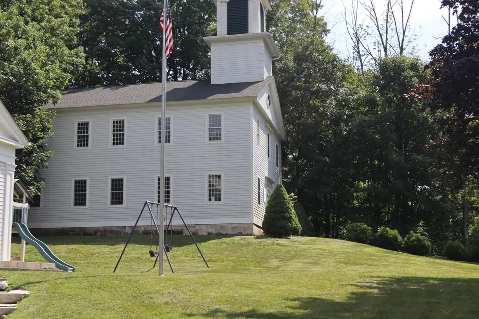 View of a small hill that leads up to the town park.