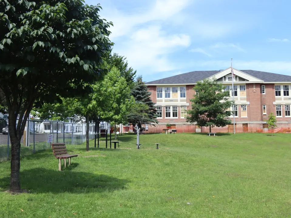 View of the playground facing west, with gentle sloping hills throughout.