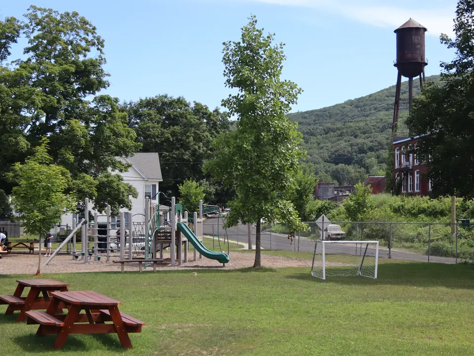 View of the memorial playground, with a small picnic area and soccer field in the foreground.