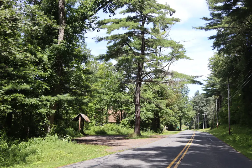 Entrance to the parking area for the Appalachian Trail (left), off Tyringham Road, facing northwest.