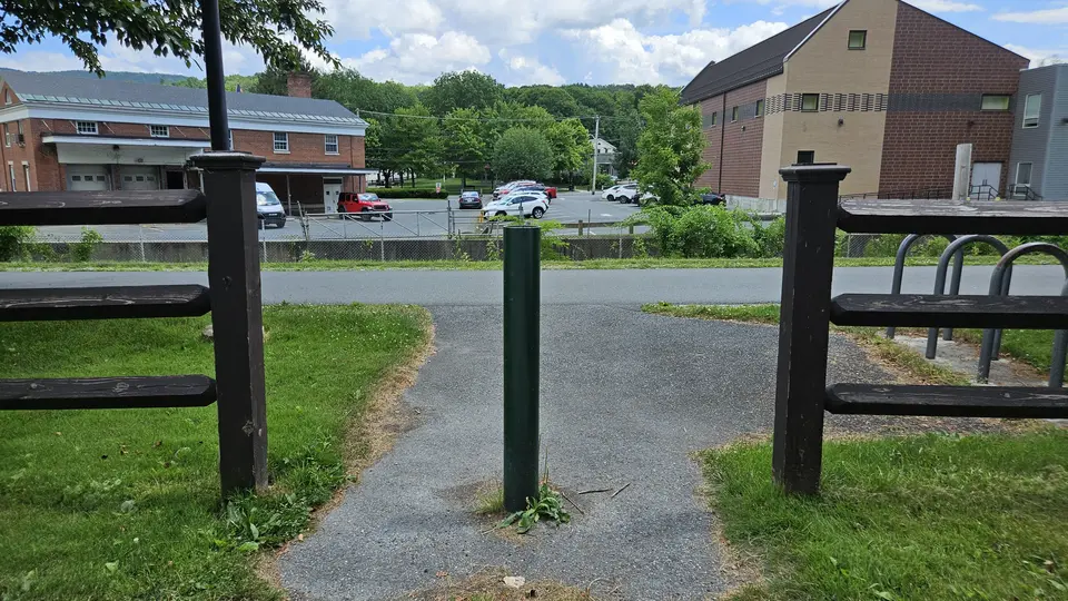 The gap in the fence to reach the trail.