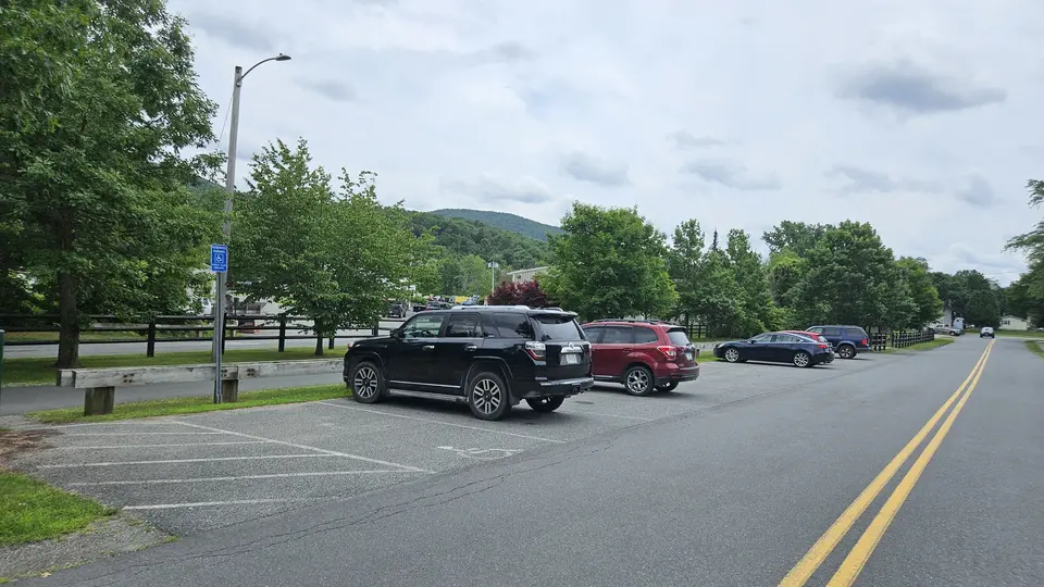 The paved parking lot with a designated handicap spot.