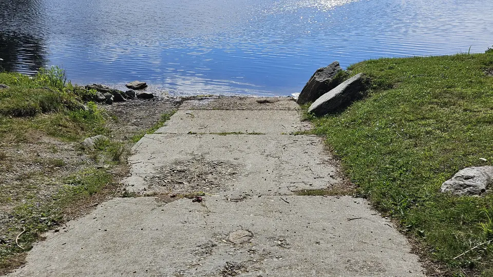 A concrete ramp leading down to the water.
