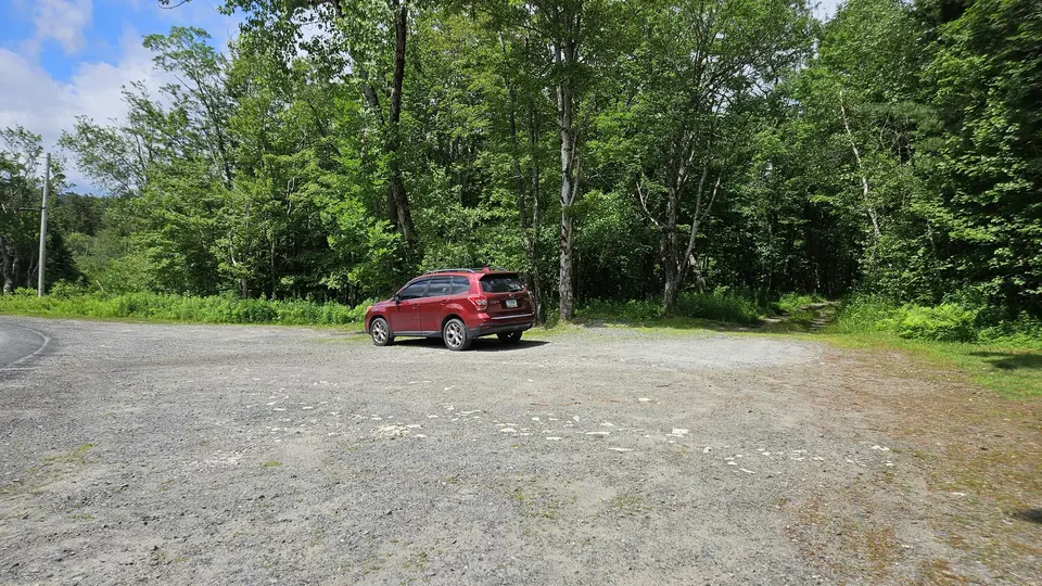 The gravel parking area.