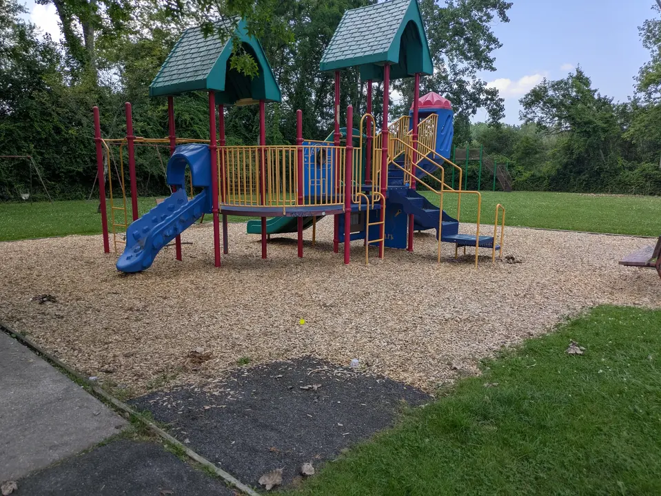 Paved ramp leading down to playground 