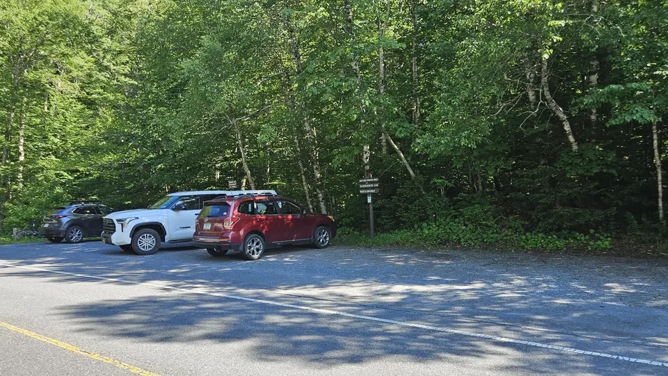 The compacted gravel parking lot.
