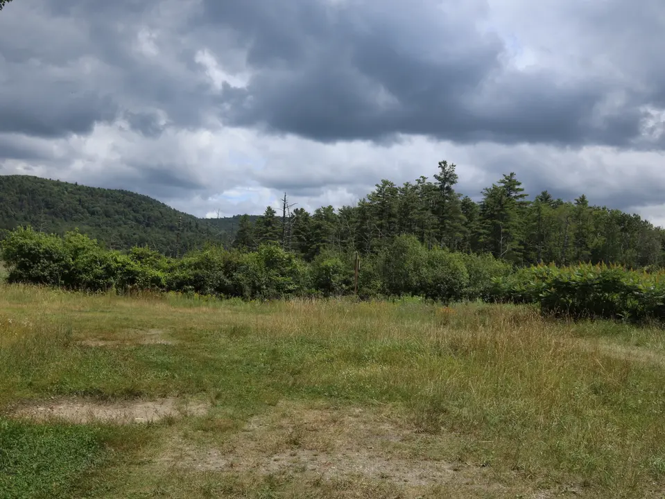 Hilly, grassy parking area for the Chestnut Preserve.