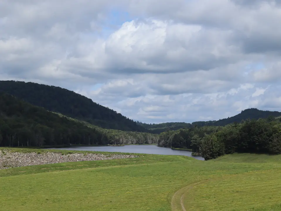 Clam Lake Flood Control Site, with the path leading to Clam Lake in the foreground.
