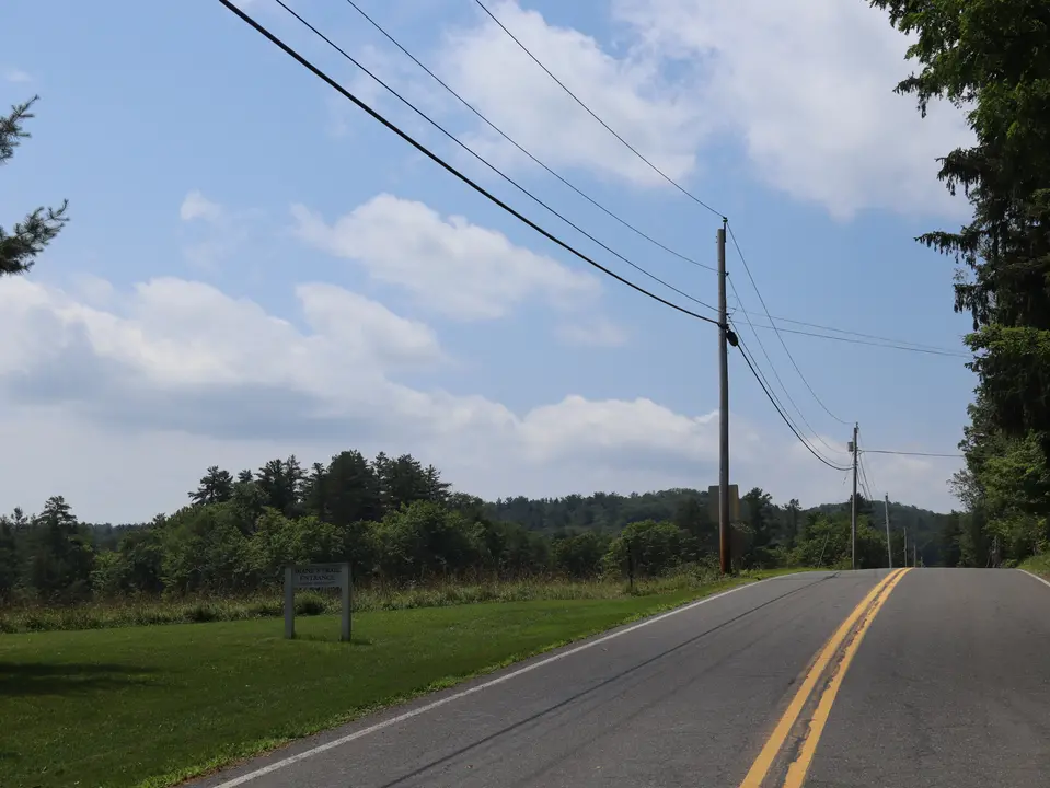View of Curtis Road. Visitors must walk down this road a quarter mile from the parking area to reach the trailhead for Diane's Trail.