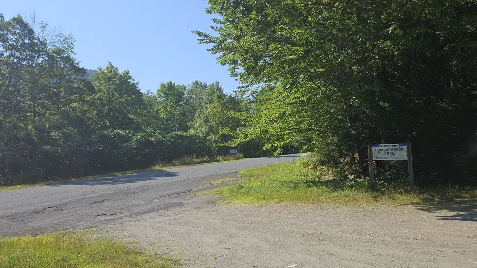 The gravel parking lot connected to the paved road.