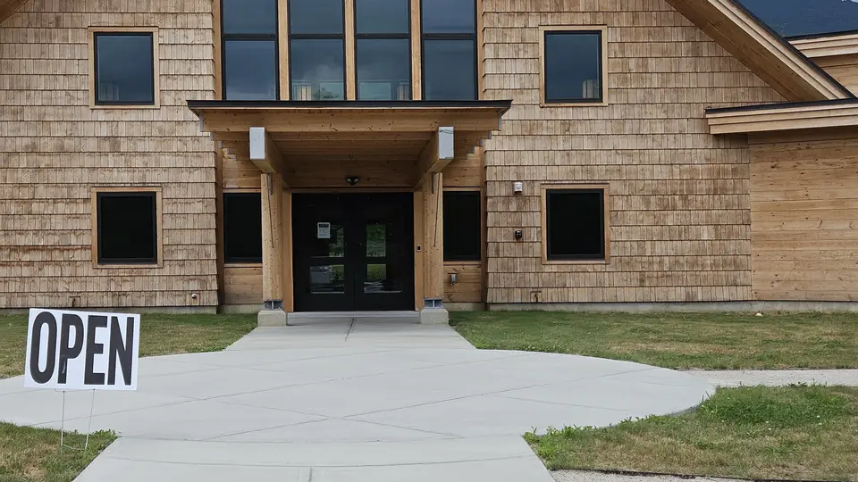 The large doors that open into the Outdoor Center, with paved sidewalks leading to them.
