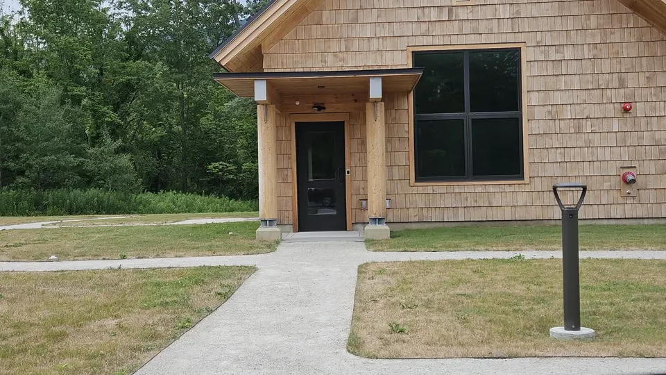 Packed gravel sidewalks leading to a door that enters the Outdoor Center.