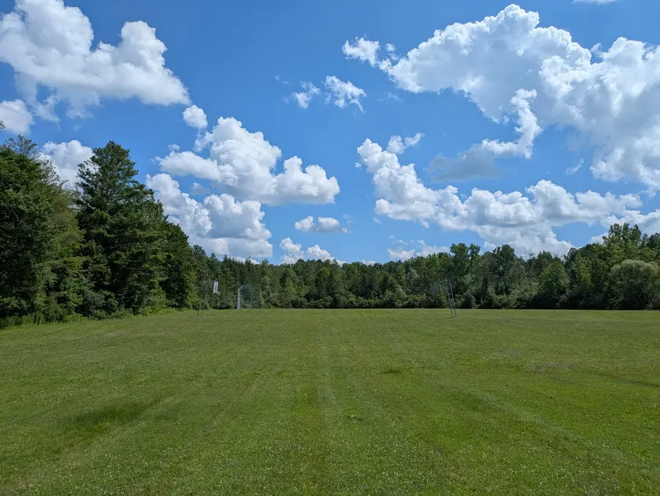 View of the grass embankment leading up to the basketball courts