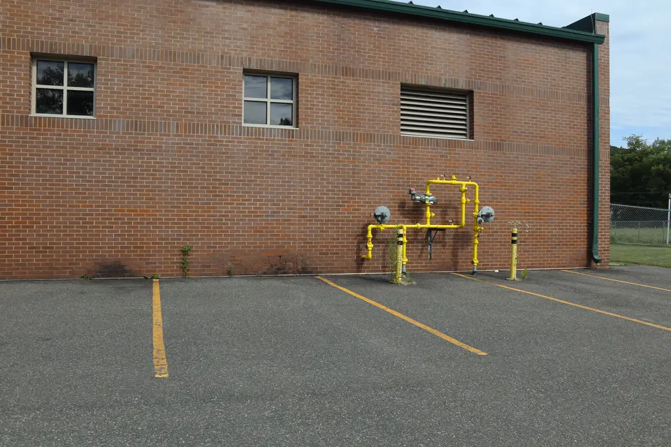 A small parking area located across from the Lee Soccer Fields, sharing room with the Lee water treatment plant.