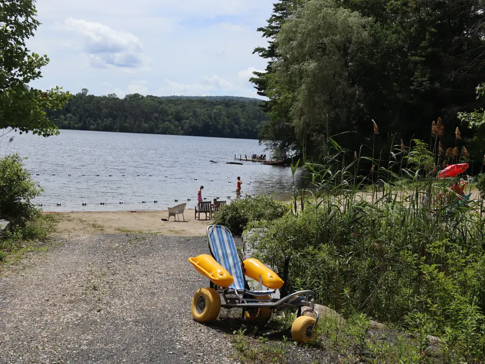 An accessible beach chair located in the accessible parking area.