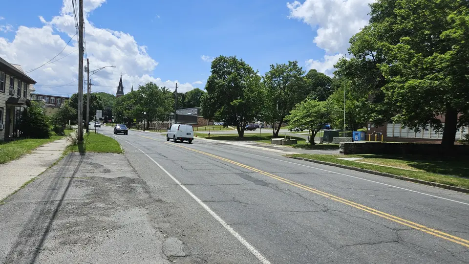 The road by the driveway to the parking area.