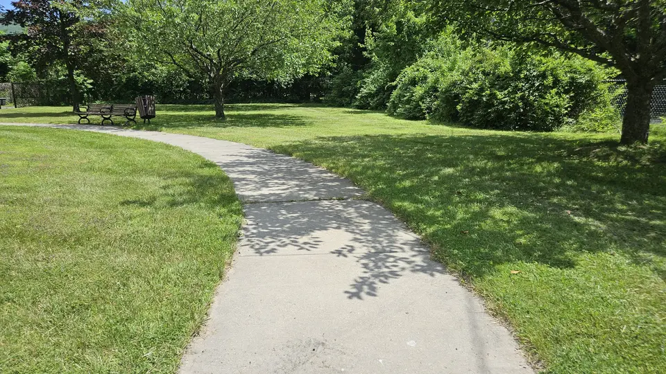 A portion of the paved path through the park.