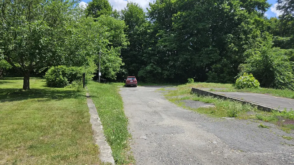 The parking area, at the bottom of a driveway.
