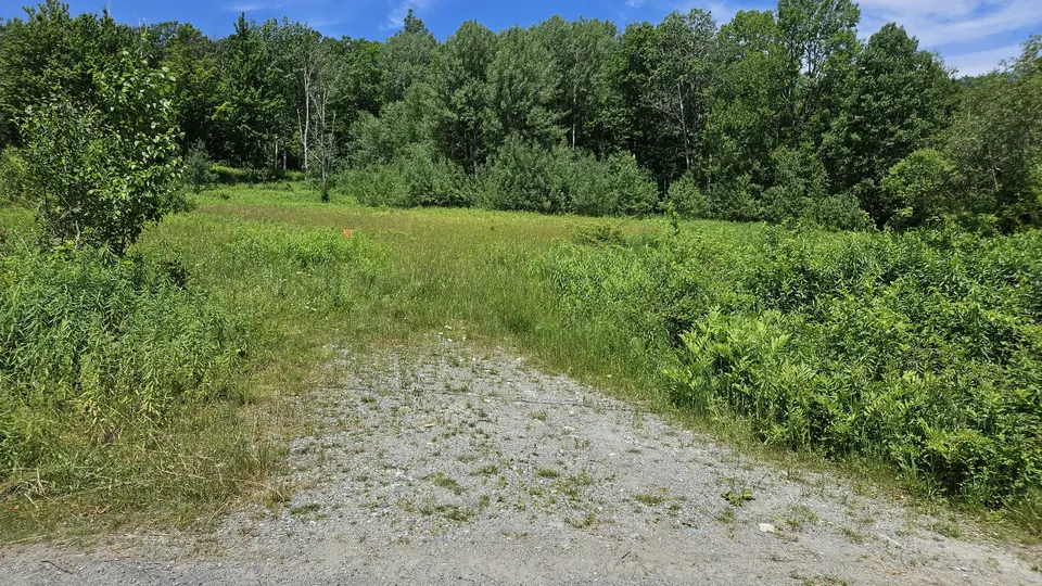 The gravel parking spot.