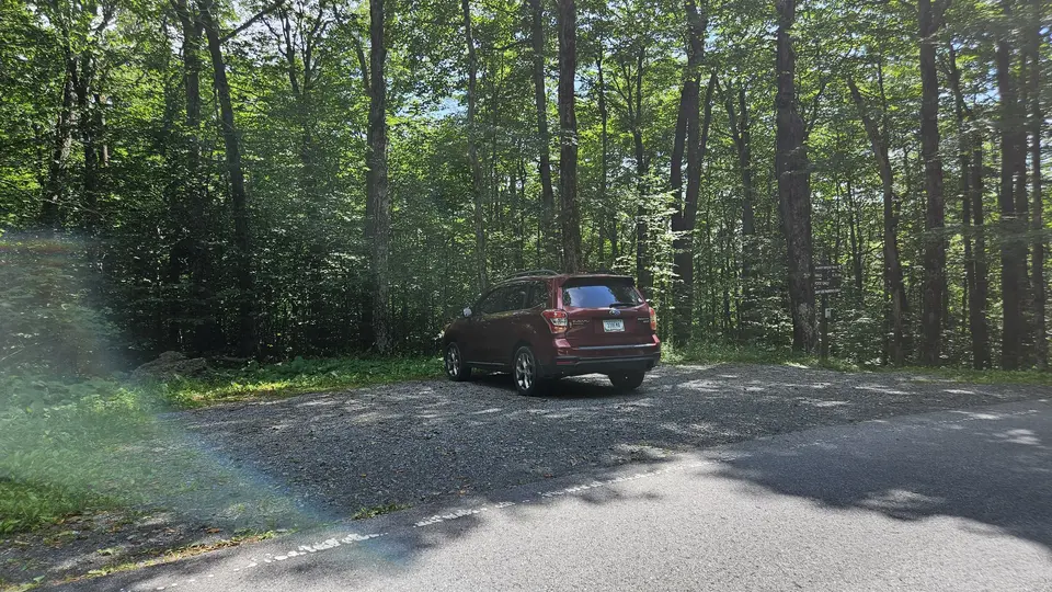 The small parking area on the side of the road.