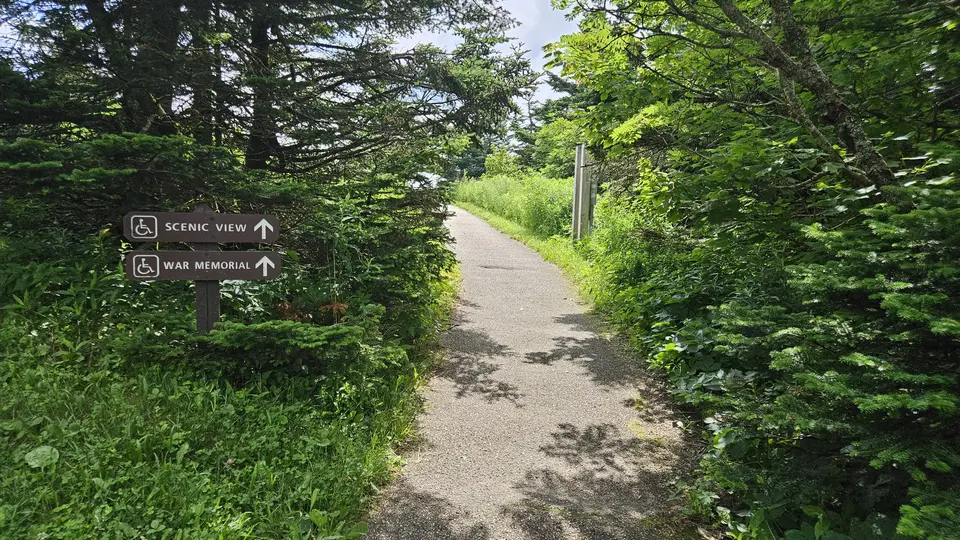 A sign indicating the handicap accessible trail to a scenic view.