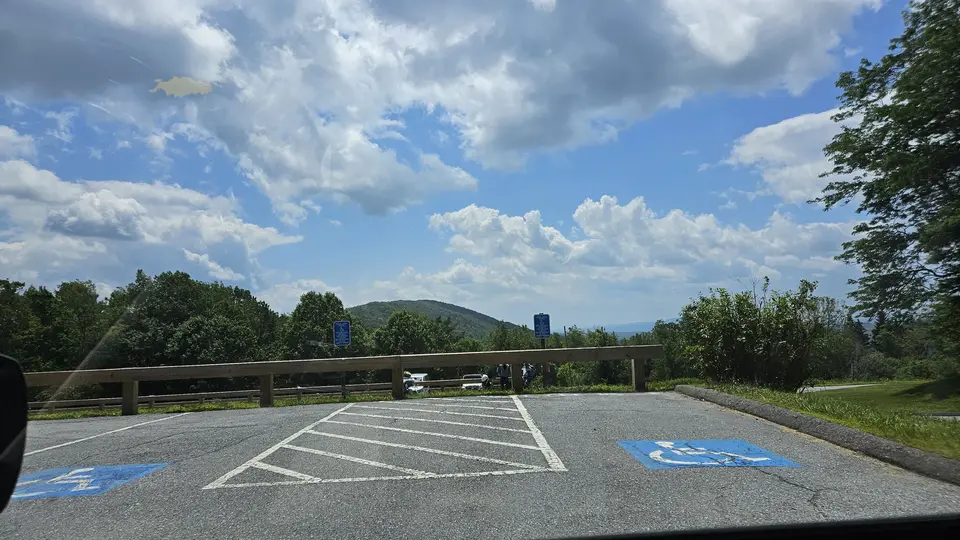 Two designated handicap parking spots in a large paved lot.