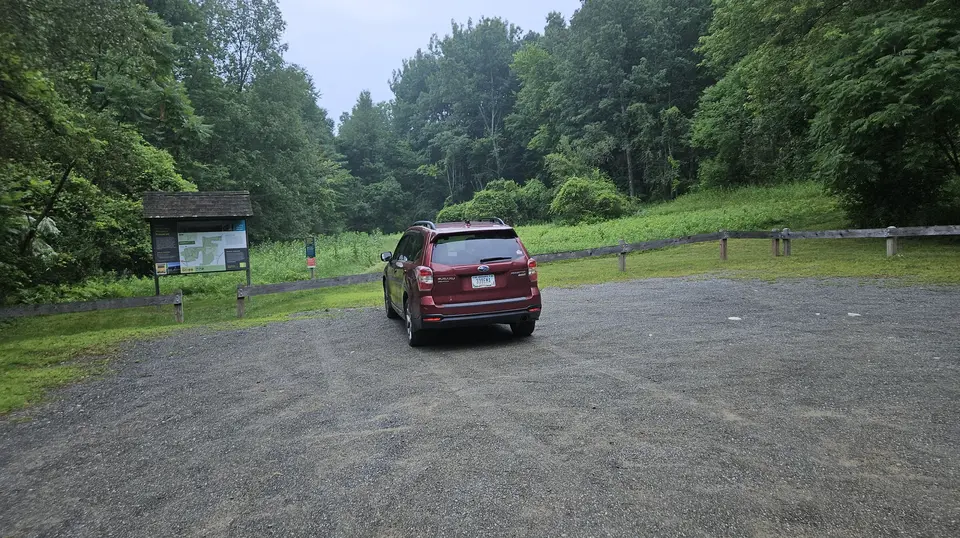The gravel parking area.