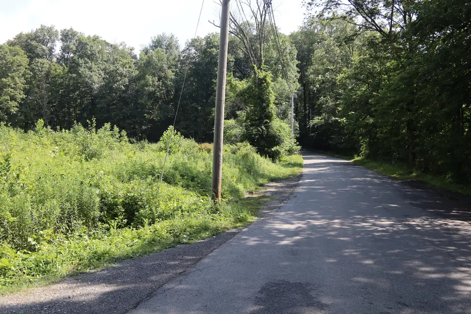 A small gravel parking area (left) off Rowe Road, which provides access to the North Egremont WMA.