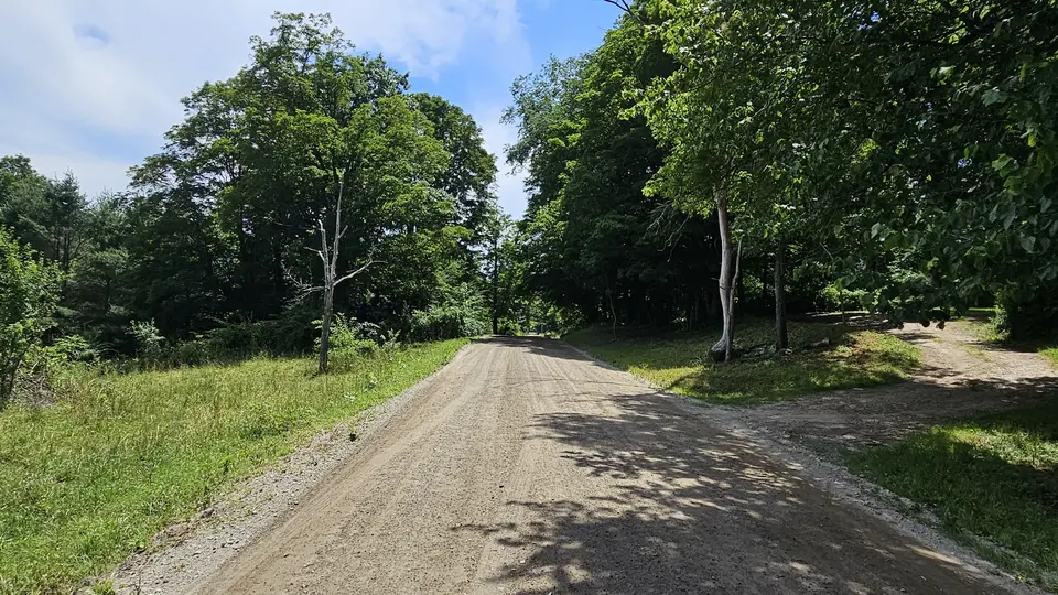 The dirt road by the parking area.