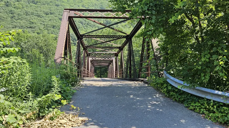 A large red metal bridge near the Preserve.