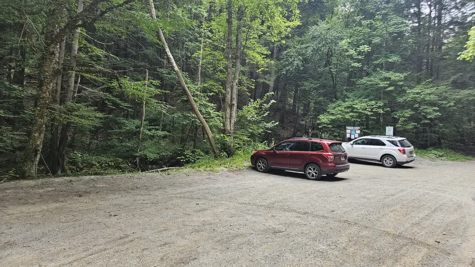 The packed gravel parking lot.