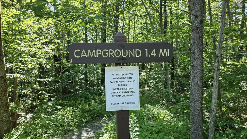 Signage for the campground, indicating hazards on the trail that necessitate a detour.