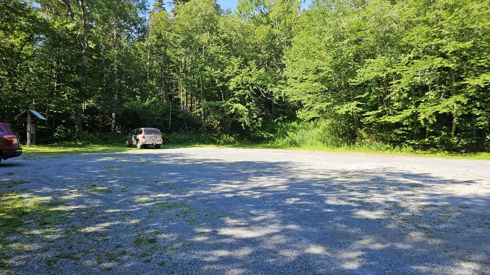 The gravel parking lot.