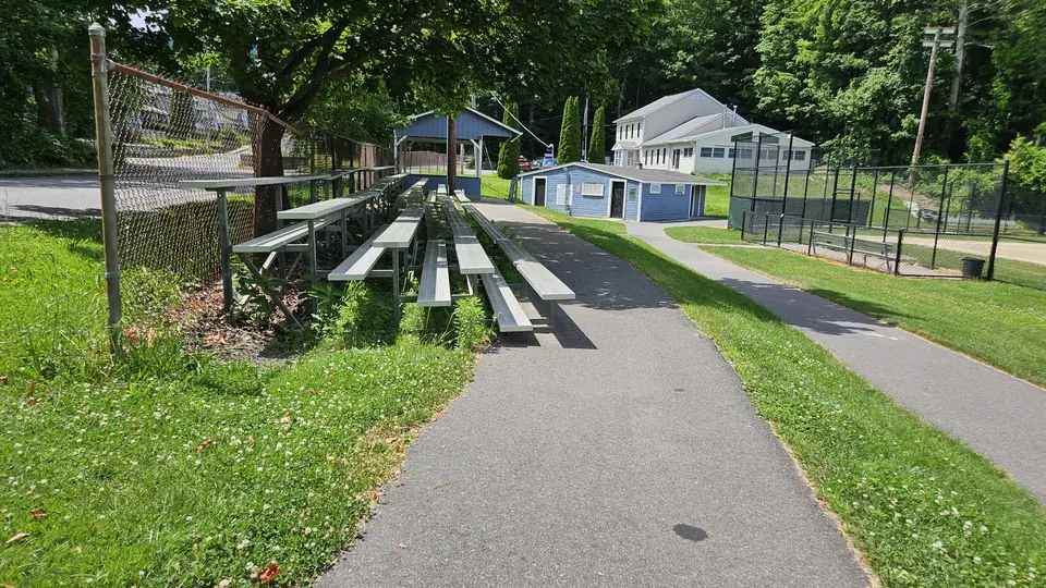 The bleachers, right next to the paved path.